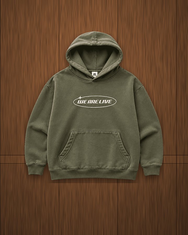 We Are Live faded hoodie in olive on a wood wall